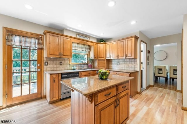 357 Minute Arms Rd, Union Twp, NJ 07083 - kitchen featuring dishwashing machine, light wood finished floors, light stone countertops, backsplash, and a kitchen island