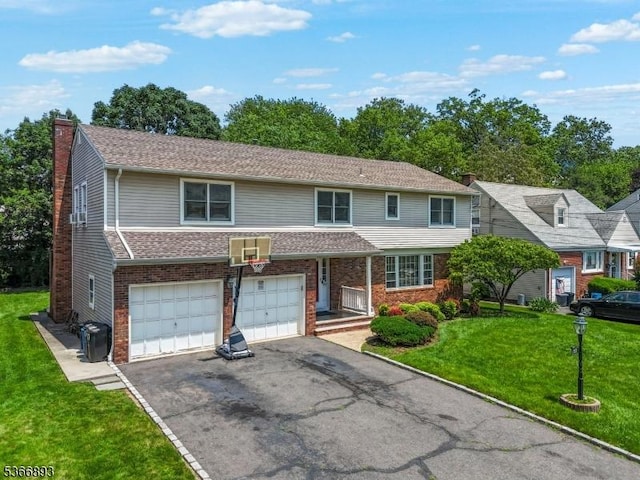 357 Minute Arms Rd, Union Twp, NJ 07083 - view of front of home with a chimney, asphalt driveway, brick siding, a garage, and a front yard