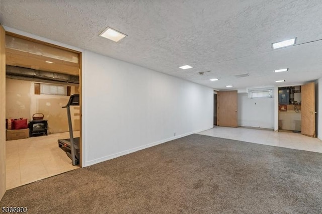 357 Minute Arms Rd, Union Twp, NJ 07083 - finished below grade area with carpet flooring, a textured ceiling, electric panel, and a wood stove