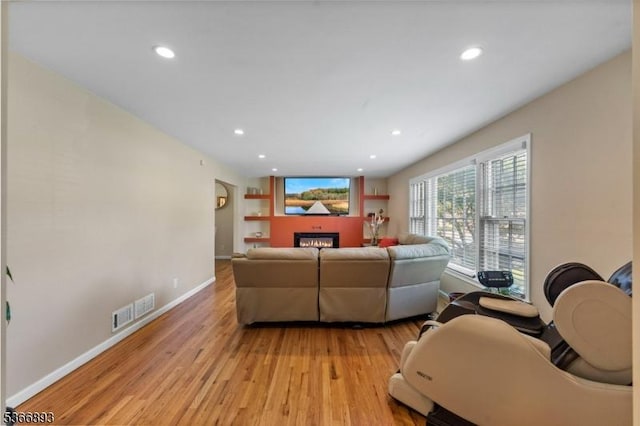 357 Minute Arms Rd, Union Twp, NJ 07083 - living area featuring light wood-style flooring, a glass covered fireplace, and recessed lighting