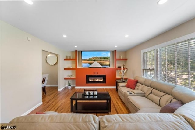 357 Minute Arms Rd, Union Twp, NJ 07083 - living room featuring wood finished floors, recessed lighting, built in shelves, and a glass covered fireplace