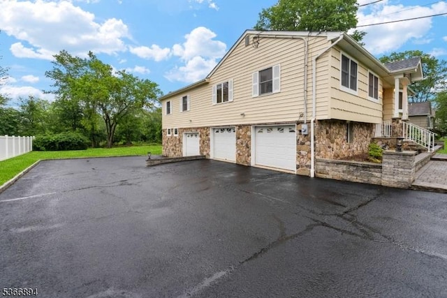 11 Hillcrest Blvd, Warren Twp, NJ 07059 - view of side of home with stone siding, asphalt driveway, and an attached garage