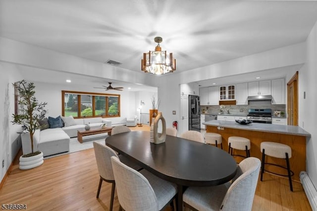 11 Hillcrest Blvd, Warren Twp, NJ 07059 - dining area featuring light wood finished floors, a chandelier, a baseboard radiator, a ceiling fan, and radiator heating unit