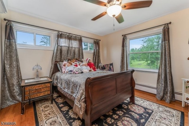 417 Mountain Rd, Readington Twp, NJ 08833 - bedroom with wood finished floors, baseboard heating, and a ceiling fan