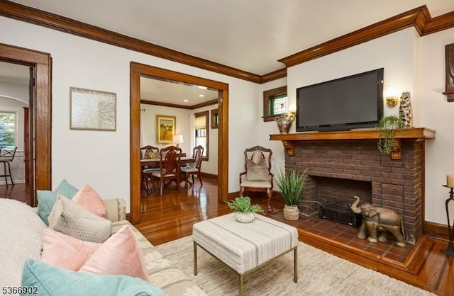 227 Parker Ave, Maplewood Twp, NJ 07040 - living area featuring wood finished floors, ornamental molding, and a brick fireplace