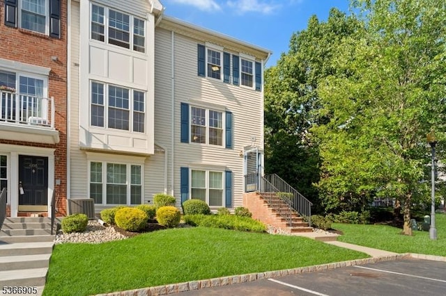4106 Dilts Ln, Bridgewater Twp, NJ 08807 - view of front facade featuring uncovered parking, stairway, and a front yard