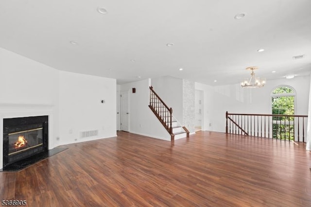 4106 Dilts Ln, Bridgewater Twp, NJ 08807 - unfurnished living room with a glass covered fireplace, wood finished floors, a chandelier, recessed lighting, and stairs