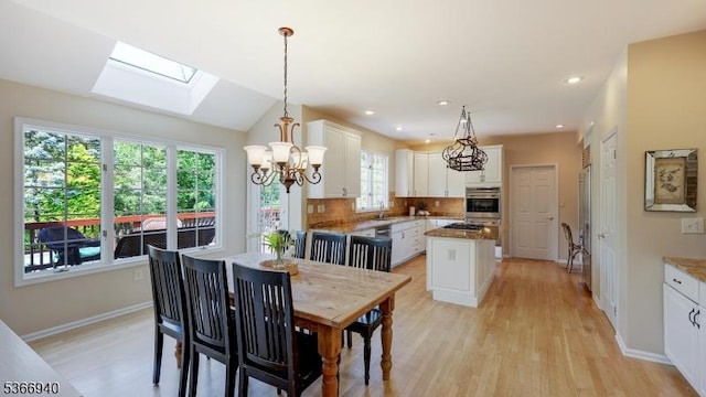 24 Montfort Dr, Montgomery Twp, NJ 08502 - dining space with a skylight, light wood-style flooring, a chandelier, recessed lighting, and vaulted ceiling