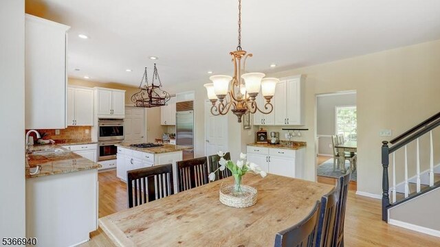 24 Montfort Dr, Montgomery Twp, NJ 08502 - dining space with a chandelier, light wood-style flooring, recessed lighting, and stairs