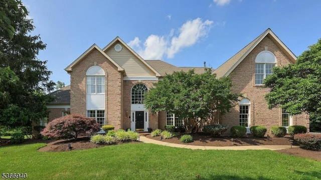24 Montfort Dr, Montgomery Twp, NJ 08502 - traditional-style house featuring a front yard and brick siding