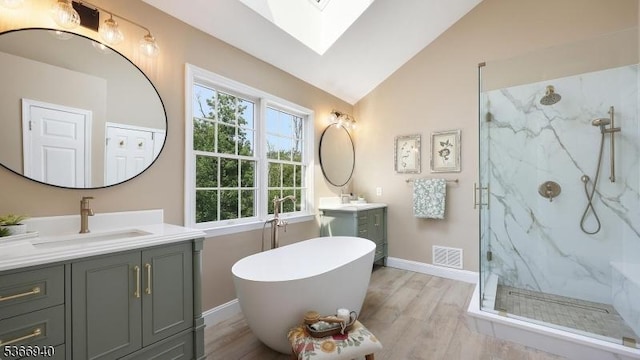 24 Montfort Dr, Montgomery Twp, NJ 08502 - full bathroom with a skylight, a marble finish shower, two vanities, wood finished floors, and lofted ceiling