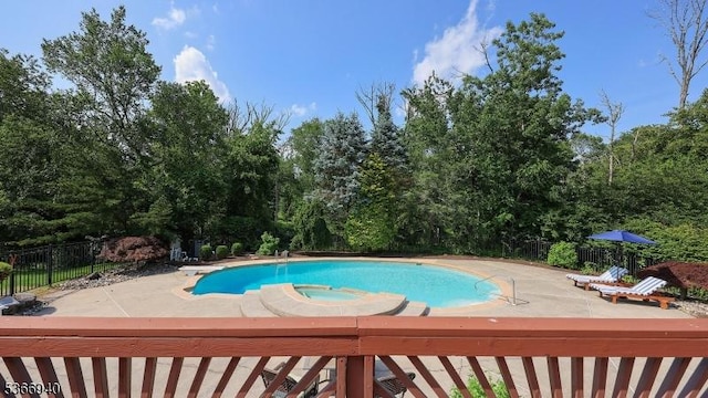 24 Montfort Dr, Montgomery Twp, NJ 08502 - view of swimming pool featuring a patio area, view of scattered trees, and a pool with connected hot tub