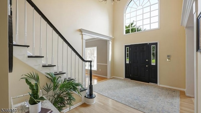 24 Montfort Dr, Montgomery Twp, NJ 08502 - entryway featuring wood finished floors, stairway, a towering ceiling, and a chandelier