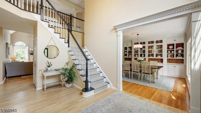 24 Montfort Dr, Montgomery Twp, NJ 08502 - foyer featuring wood finished floors, stairway, a towering ceiling, and a chandelier