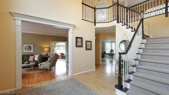 24 Montfort Dr, Montgomery Twp, NJ 08502 - entrance foyer with plenty of natural light, wood finished floors, stairway, a towering ceiling, and ornamental molding