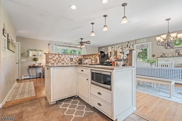 28 Old Beaver Run Rd, Lafayette Twp, NJ 07848 - kitchen featuring stainless steel microwave, ceiling fan, a baseboard heating unit, a chandelier, and tasteful backsplash