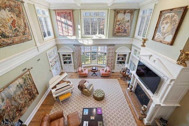 141 Mountaintop Rd, Bernardsville Boro, NJ 07924 - living area featuring a fireplace with raised hearth, wood finished floors, a towering ceiling, and ornamental molding