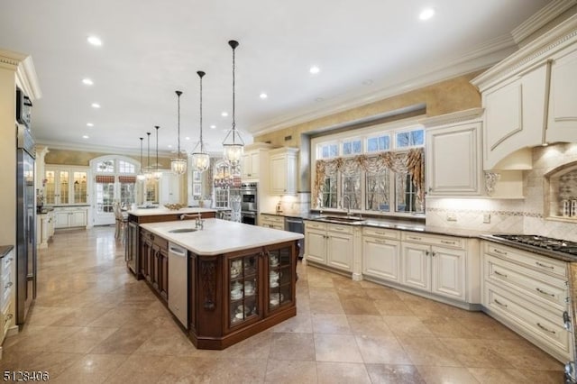 141 Mountaintop Rd, Bernardsville Boro, NJ 07924 - kitchen with appliances with stainless steel finishes, cream cabinetry, ornamental molding, tasteful backsplash, and a large island with sink