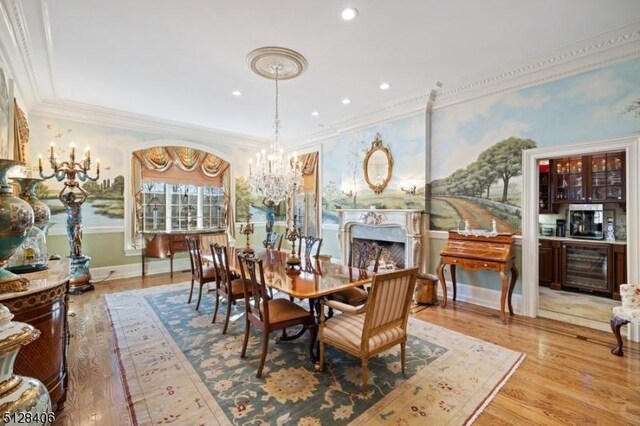 141 Mountaintop Rd, Bernardsville Boro, NJ 07924 - dining room featuring wine cooler, a chandelier, ornamental molding, wood finished floors, and recessed lighting