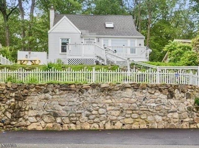 520 Dell Rd, Roxbury Twp, NJ 07850 - view of front of home featuring a chimney, a fenced front yard, and a shingled roof