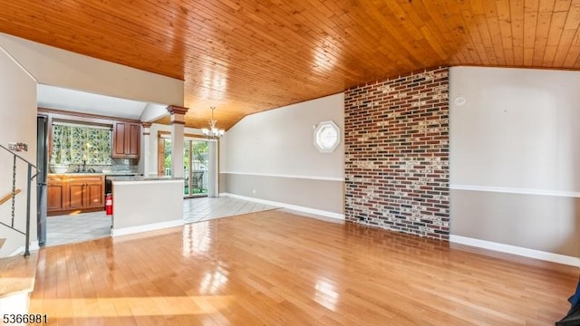 32 Washington Ave, Edgewater Park Twp, NJ 08010 - unfurnished living room featuring lofted ceiling, wooden ceiling, a chandelier, light wood-style flooring, and decorative columns