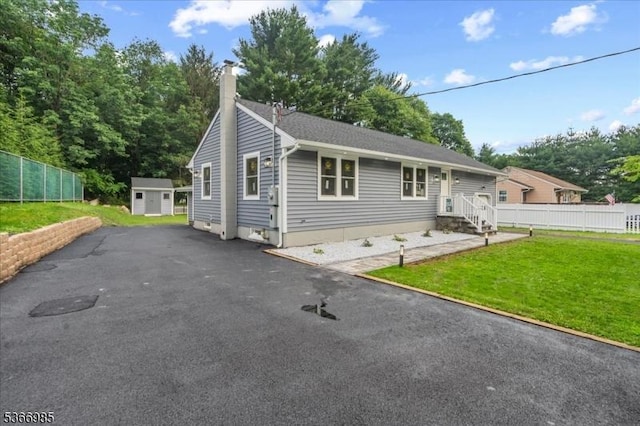 204 Christopher St, Hackettstown Town, NJ 07840 - view of front of property featuring a chimney, a storage shed, asphalt driveway, and entry steps