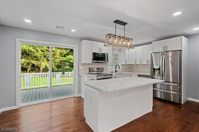 204 Christopher St, Hackettstown Town, NJ 07840 - kitchen featuring stainless steel appliances, dark wood-style floors, light stone counters, white cabinets, and a kitchen island