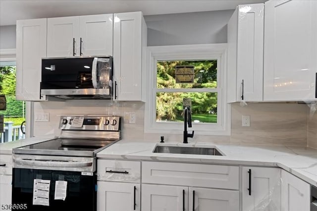 204 Christopher St, Hackettstown Town, NJ 07840 - kitchen featuring appliances with stainless steel finishes, white cabinets, healthy amount of natural light, and tasteful backsplash