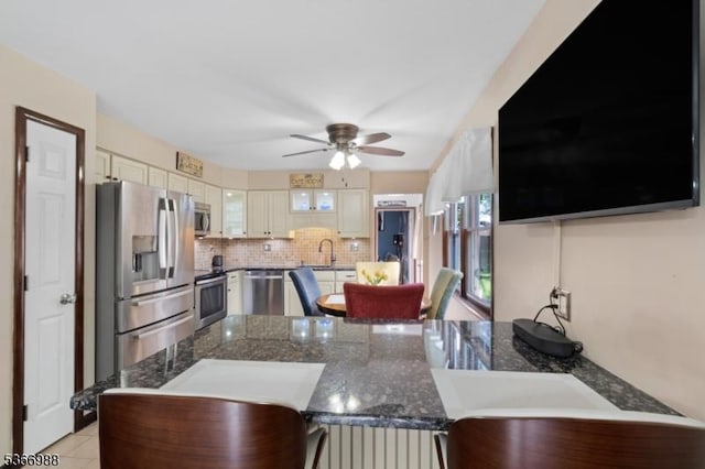 11 Washington St, Mount Olive Twp, NJ 07828 - kitchen featuring stainless steel appliances, a peninsula, glass insert cabinets, a ceiling fan, and tasteful backsplash