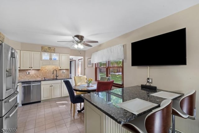 11 Washington St, Mount Olive Twp, NJ 07828 - kitchen with appliances with stainless steel finishes, a breakfast bar area, a peninsula, tasteful backsplash, and a ceiling fan