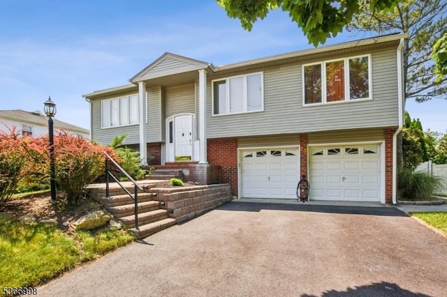 23 Midway Ct, Rockaway Twp, NJ 07866 - raised ranch with brick siding, a garage, and asphalt driveway