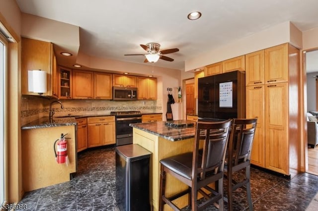 23 Midway Ct, Rockaway Twp, NJ 07866 - kitchen with appliances with stainless steel finishes, a ceiling fan, a kitchen breakfast bar, glass insert cabinets, and a center island
