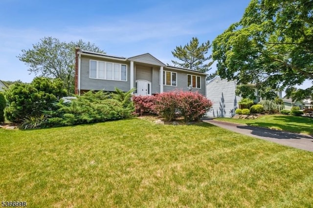 23 Midway Ct, Rockaway Twp, NJ 07866 - raised ranch featuring a front lawn and a chimney