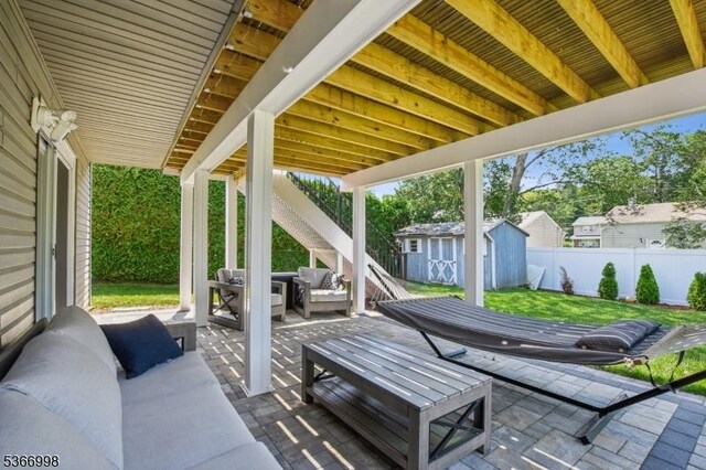 23 Midway Ct, Rockaway Twp, NJ 07866 - fenced backyard featuring an outdoor hangout area, a patio, and a storage unit