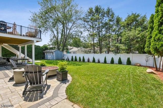 23 Midway Ct, Rockaway Twp, NJ 07866 - fenced backyard with a patio, a storage shed, and an outdoor fire pit