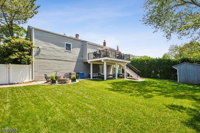 23 Midway Ct, Rockaway Twp, NJ 07866 - rear view of house featuring stairs, a storage unit, a wooden deck, a chimney, and a patio