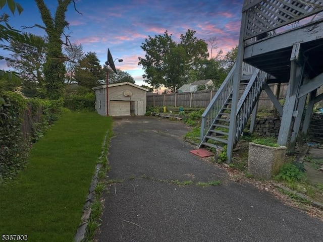 979 Lorraine Ave, Union Twp, NJ 07083 - yard at dusk with an outbuilding, stairway, a garage, and driveway
