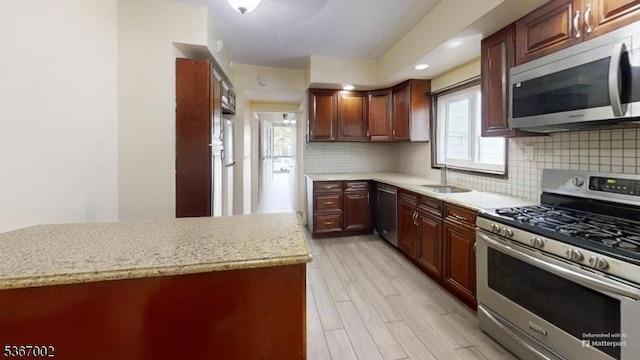 979 Lorraine Ave, Union Twp, NJ 07083 - kitchen with appliances with stainless steel finishes, tasteful backsplash, light wood finished floors, and light stone countertops