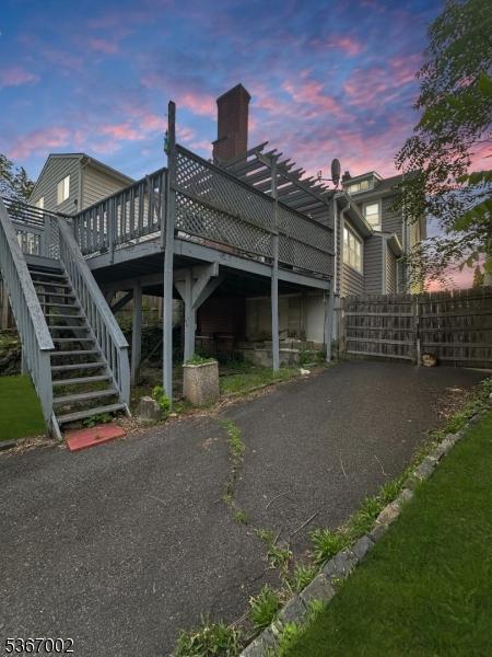 979 Lorraine Ave, Union Twp, NJ 07083 - back of property at dusk with a wooden deck and stairs