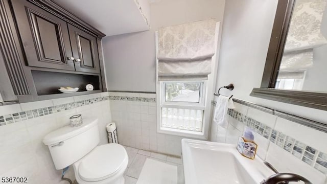 979 Lorraine Ave, Union Twp, NJ 07083 - bathroom featuring tile walls, healthy amount of natural light, tile patterned flooring, and a wainscoted wall