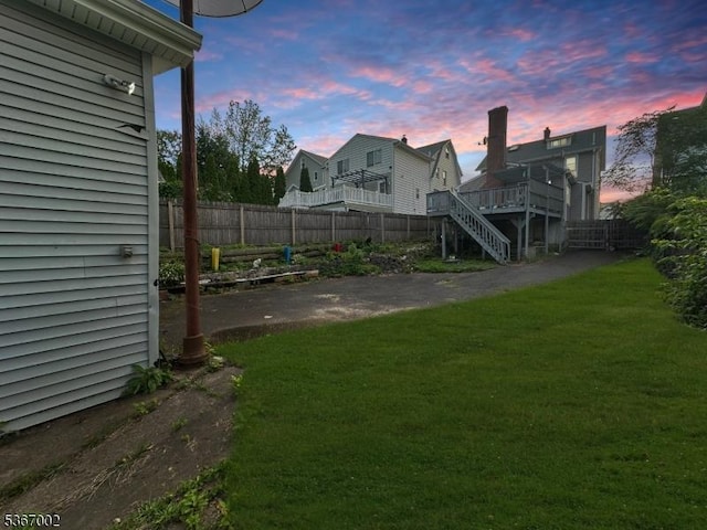 979 Lorraine Ave, Union Twp, NJ 07083 - yard at dusk featuring a fenced backyard, a deck, and stairway