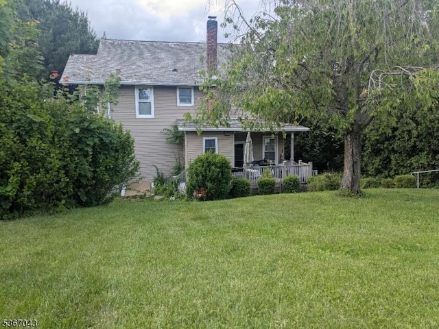 43 Main St, Hampton Boro, NJ 08827 - rear view of property featuring a chimney, a lawn, and covered porch