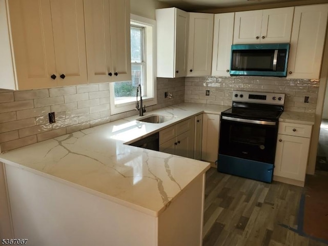 4 Bear Pond Trl, Hopatcong Boro, NJ 07821 - kitchen featuring electric range oven, stainless steel microwave, light wood-style floors, light stone countertops, and a peninsula