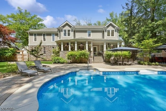 1 Bates Way, Westfield Town, NJ 07090 - rear view of property featuring an outdoor pool, a patio, and stone siding