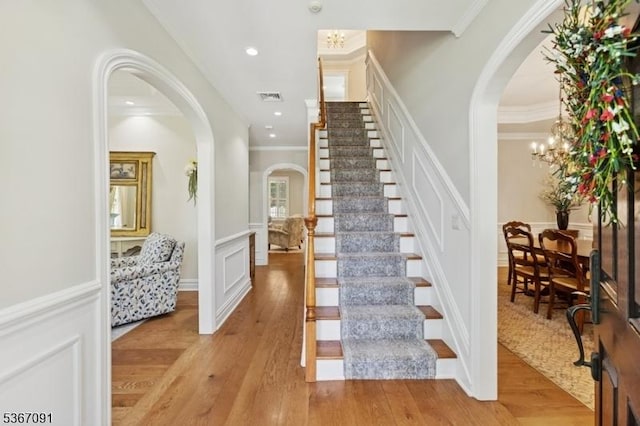 1 Bates Way, Westfield Town, NJ 07090 - staircase with arched walkways, crown molding, wainscoting, wood finished floors, and a decorative wall