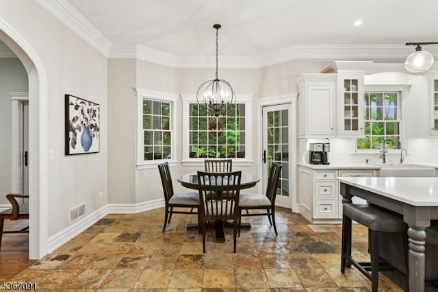 1 Bates Way, Westfield Town, NJ 07090 - dining area featuring stone tile flooring, arched walkways, a chandelier, ornamental molding, and recessed lighting