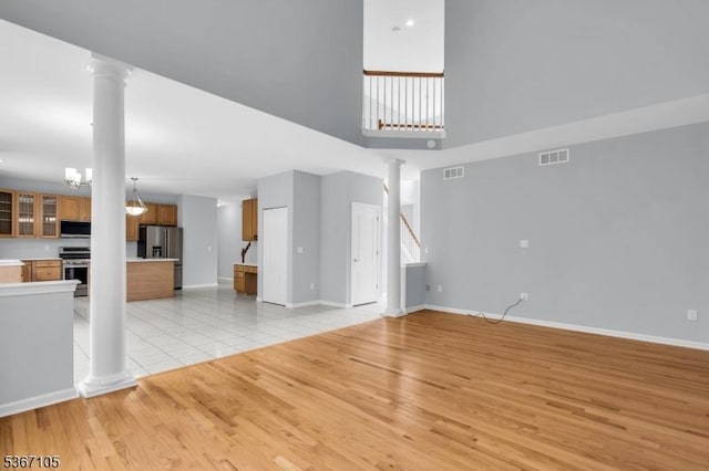 3 Whisper Way, Barnegat Twp, NJ 08005 - unfurnished living room with ornate columns, light wood finished floors, and a high ceiling