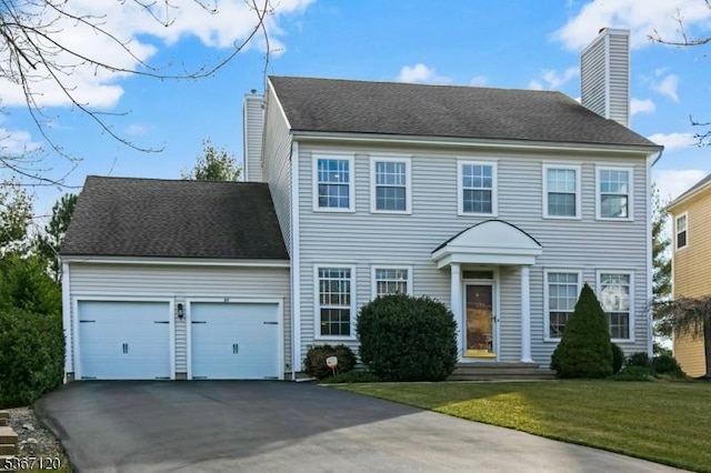 51 Carlisle Rd, Bernards Twp, NJ 07920 - colonial house featuring a chimney, driveway, an attached garage, and a front yard