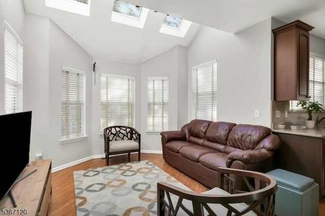 51 Carlisle Rd, Bernards Twp, NJ 07920 - living room featuring a skylight, healthy amount of natural light, lofted ceiling, and light wood-style floors