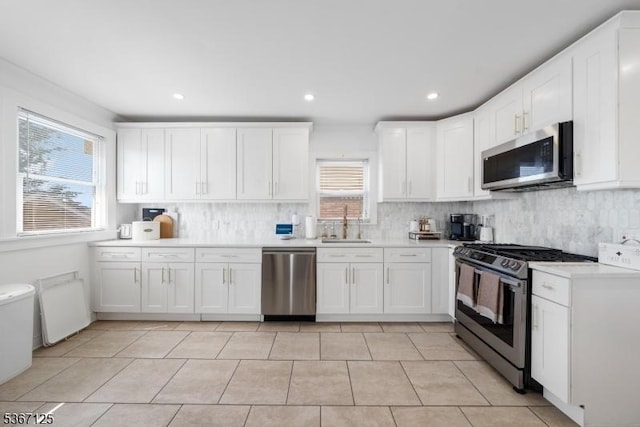 1697 Van Ness Ter, Union Twp, NJ 07083 - kitchen with appliances with stainless steel finishes, white cabinetry, tasteful backsplash, light countertops, and recessed lighting